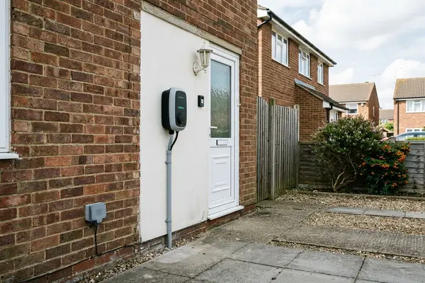 Illustration of an electric car charging point on a house wall